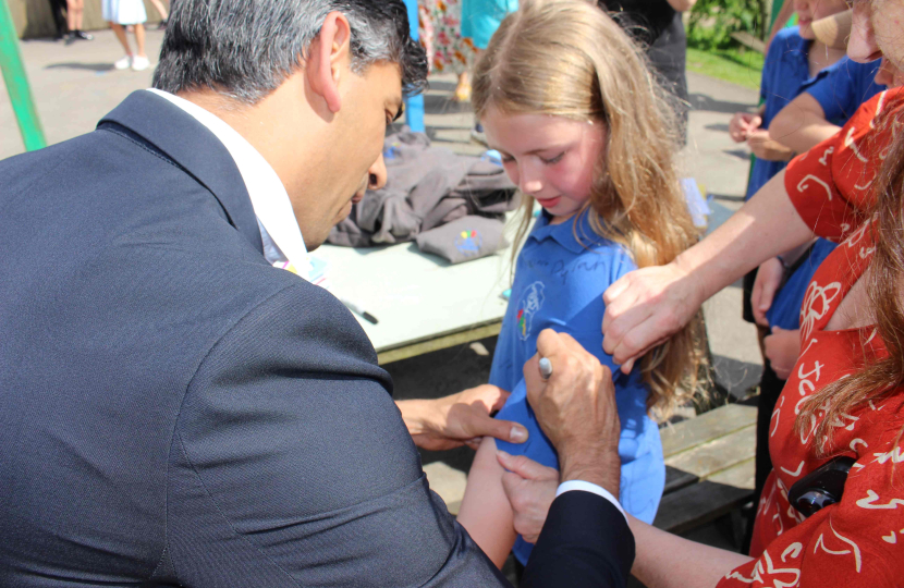 Rishi Sunak signs a leaver's shirt at Askrigg Primary School